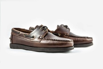 Classic leather shoes in a white background. Brown moccasins.