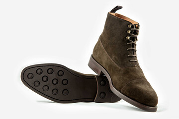 Classic leather shoes in a white background.  Classic brown suede boots.