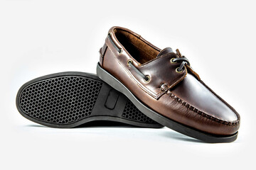 Classic leather shoes in a white background. Brown moccasins.