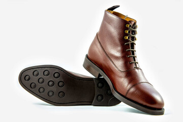 Classic light brown leather shoes in a white background. 