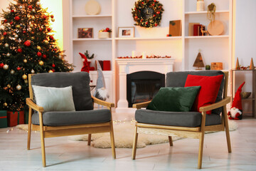 Fireplace, armchairs, Christmas tree and festive decor in stylish room