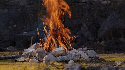 Beautiful Crackling Campfire in a Rocky Landscape among the Pines, Sunrise , Authentic Place