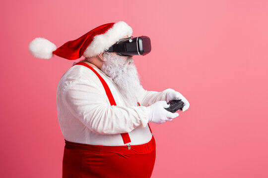 Santa in red suit wearing headset and playing game with controller in festive scene celebrating Christmas Eve with family fun and holiday joy