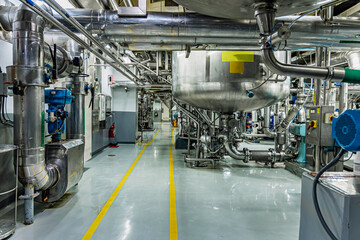 Stainless vertical steel tanks and pipes with pressure meter in equipment tank chemical cellar at the with stainless steel