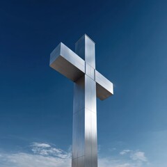 Fototapeta premium Towering metal cross against clear blue sky with clouds