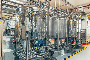 Stainless vertical steel tanks and pipes with pressure meter in equipment tank chemical cellar at the with stainless steel