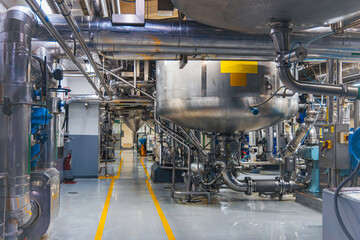 Stainless vertical steel tanks and pipes with pressure meter in equipment tank chemical cellar at the with stainless steel