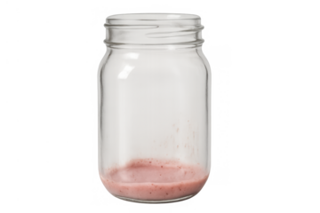 Empty glass jar showing pink smoothie residue at bottom, finishing a healthy drink, transparent background