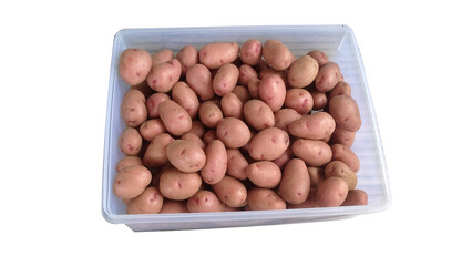 Fresh pink potatoes in a clear plastic container. High-quality raw potatoes for cooking, market display, food ingredients, and agricultural product promotions