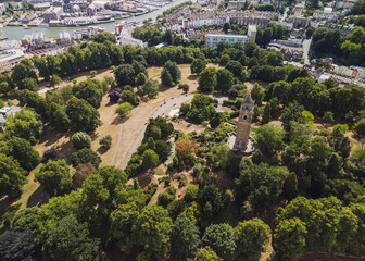 Bristol UK: 28th July 2025: Breathtaking drone view of Cabot Tower surrounded by lush greenery of Brandon Hill park. With the harbour in background