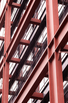 A clean architecture facade formulation blending geometry, abstract structure and contrast with minimalism, integrating a defined red surface framed by lines and rhythmic pattern.