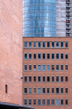 Contemporary architecture facade imagery showcasing geometry, angle and abstract structure, built around contrast and a precise red accent complemented by lines and textured detail.