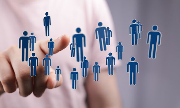 Hand pointing towards digital human icons. Represents networking, teamwork, and the concept of human connection - Powered by Adobe