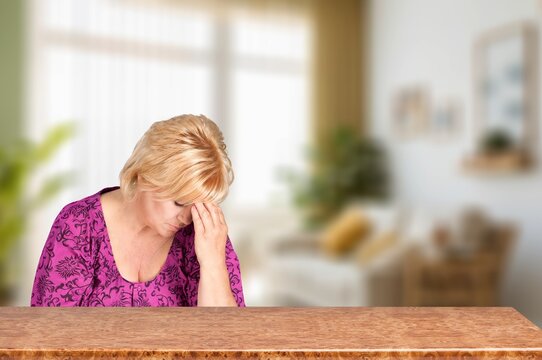 Upset senior woman sitting looking away