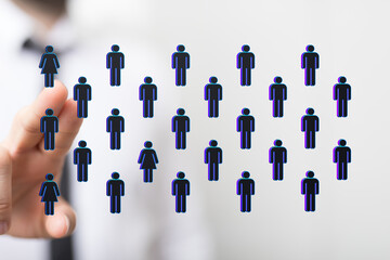 Hand touching digital icons representing people, showcasing concepts like network, communication, teamwork, and