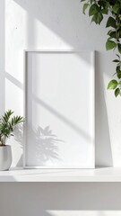 Fototapeta premium White Frame Mockup with Plant and Sunlight Shadows on a Shelf.