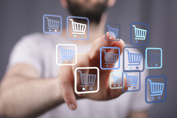 Person interacting with shopping cart symbols, representing online shopping, digital store, and e-commerce transactions and consumerism.