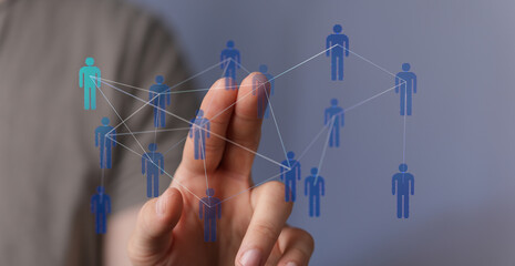 Hand reaching towards a digital human network. Teamwork and communication concept. Network of people connected with each other. Business, intern