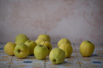 Fresh apples on decorative ceramic tiles, ideal for culinary content, grocery advertising and healthy lifestyle materials.