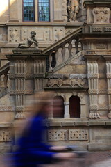 Leiden Street View with Town Hall Exterior Detail and Passing Woman in Blue, Netherlands