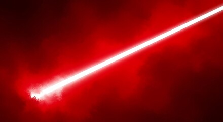Vibrant red laser beam cutting through darkness creating a dramatic and intense visual effect