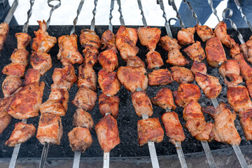 Delicious grilled meat skewers on a hot barbecue grill