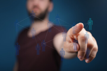 Fototapeta premium Hand pointing at a network of people. Symbol of connection, communication, social media, and collaboration. Mod