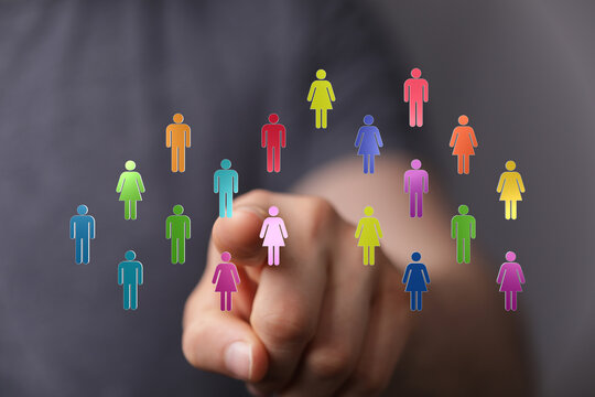 Hand pointing at colorful people icons representing diverse community, connection, and social network.