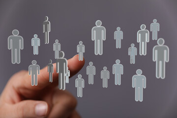 Hand pointing at floating people icons representing teamwork and networking, with concepts like community and c