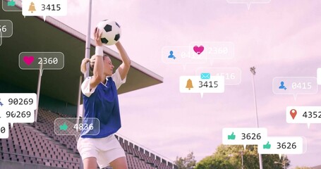 Preparing female soccer player holding soccer ball overhead at sideline, in blue bib social icons