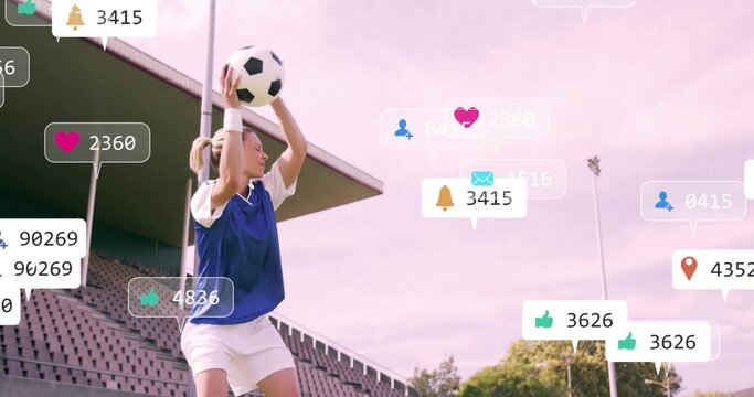 Preparing female soccer player holding soccer ball overhead at sideline, in blue bib social icons