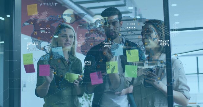 Pointing, three colleagues in casual shirts discussing plans at open office glass board, Post-its - Powered by Adobe