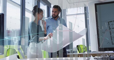 Reviewing blueprint, woman in blouse and man in buttoned shirt at office, with green chairs charts
