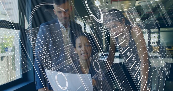 Reviewing woman in blazer holding printed sheet and leaning at desk in glass office, holograms - Powered by Adobe