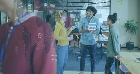 Discussing three team members in casual business attire holding reusable coffee cup by glass map