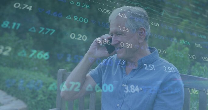 Smiling senior in blue shirt holding smartphone to ear, talking on wood bench, garden, data overlay - Powered by Adobe