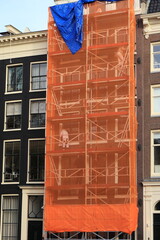 Scaffolding with Orange Construction Screen in Amsterdam, Netherlands