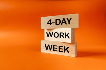 4-day work week. Business and financial concept. Shortening from 5 to 4 work days. written on wooden blocks. orange background, copy space. Supporting family, burdening business