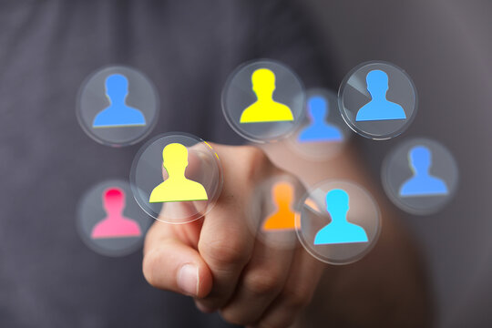 Hand touching digital human icons representing connection, teamwork, and networking concepts. Modern technology visualized for business and comm