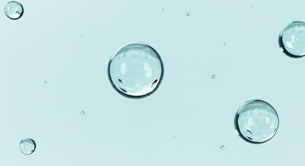 Closeup of clear water bubbles floating on a light blue background