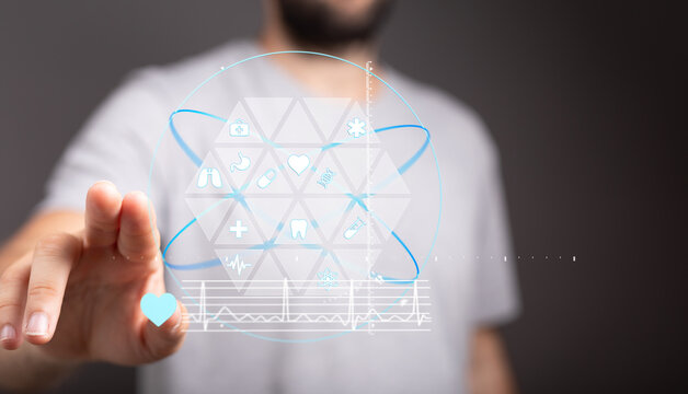 High-quality stock photo of a man interacting with a digital interface showing medical icons and data. Perfect for healthcare, techno - Powered by Adobe