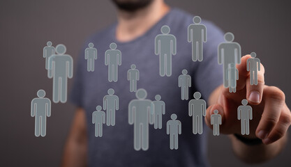 Close up shot of a man pointing at a network of digital human figures representing social connections and busin