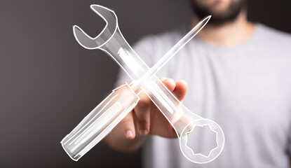 Hand holding digital wrench and screwdriver. Repair, maintenance, support concept.