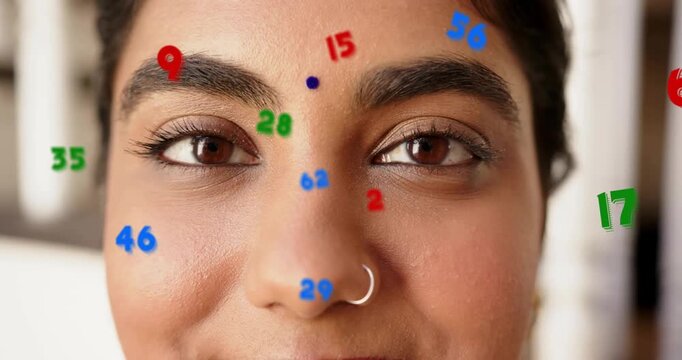 woman opening eyes and fixing gaze, animated numbers tracking nose ring and bindi for tech