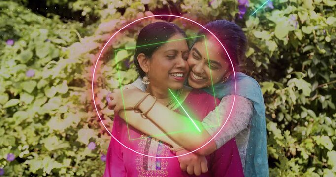 Mom-daughter standing in garden glowing circle appearing neon shapes tracing arms and faces for ad