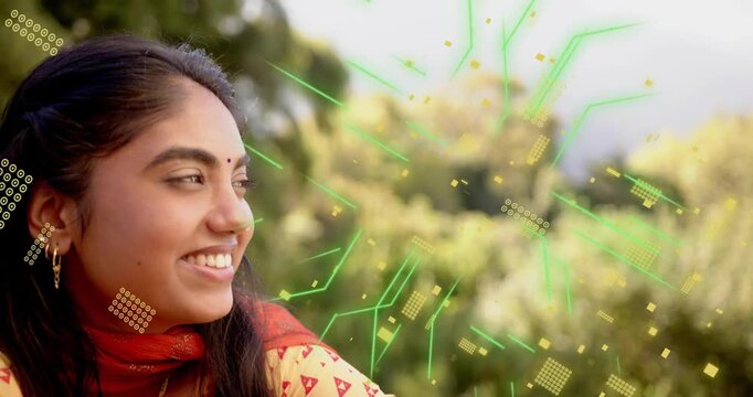 Woman facing right smiling, on play starting green circuit particles drifting over cheek for tech