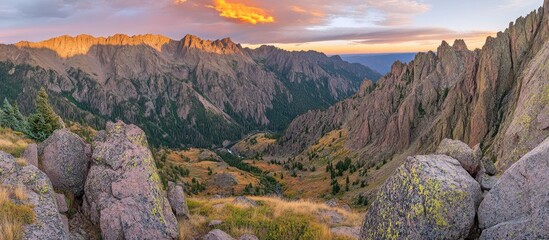 Majestic Mountain Valley Bathed in Golden Hour Sunset Light, Rugged Peaks and Autumn Foliage