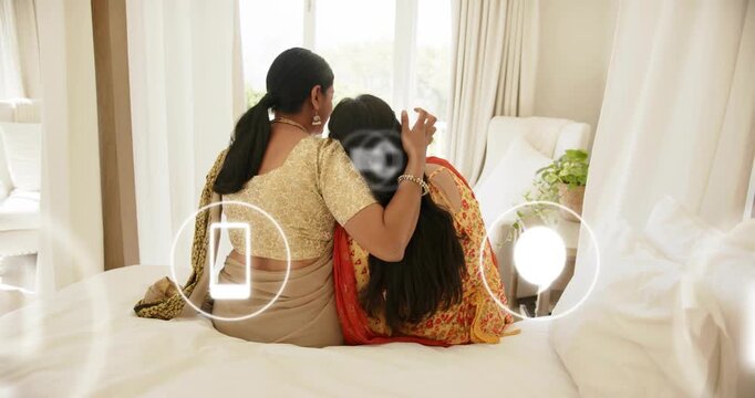 Mom and daughter sitting on bed mail-chat icons rising showing comms flow while mom stroking hair