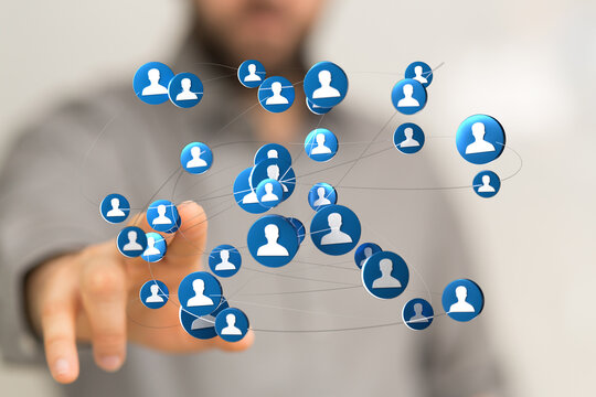 Close-up of a hand connecting digital icons representing people in a network. Ideal for concepts of social media, teamwork, digital networking a