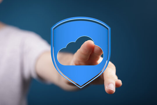 Hand touching digital cloud security shield, representing data protection and cyber security in modern network.